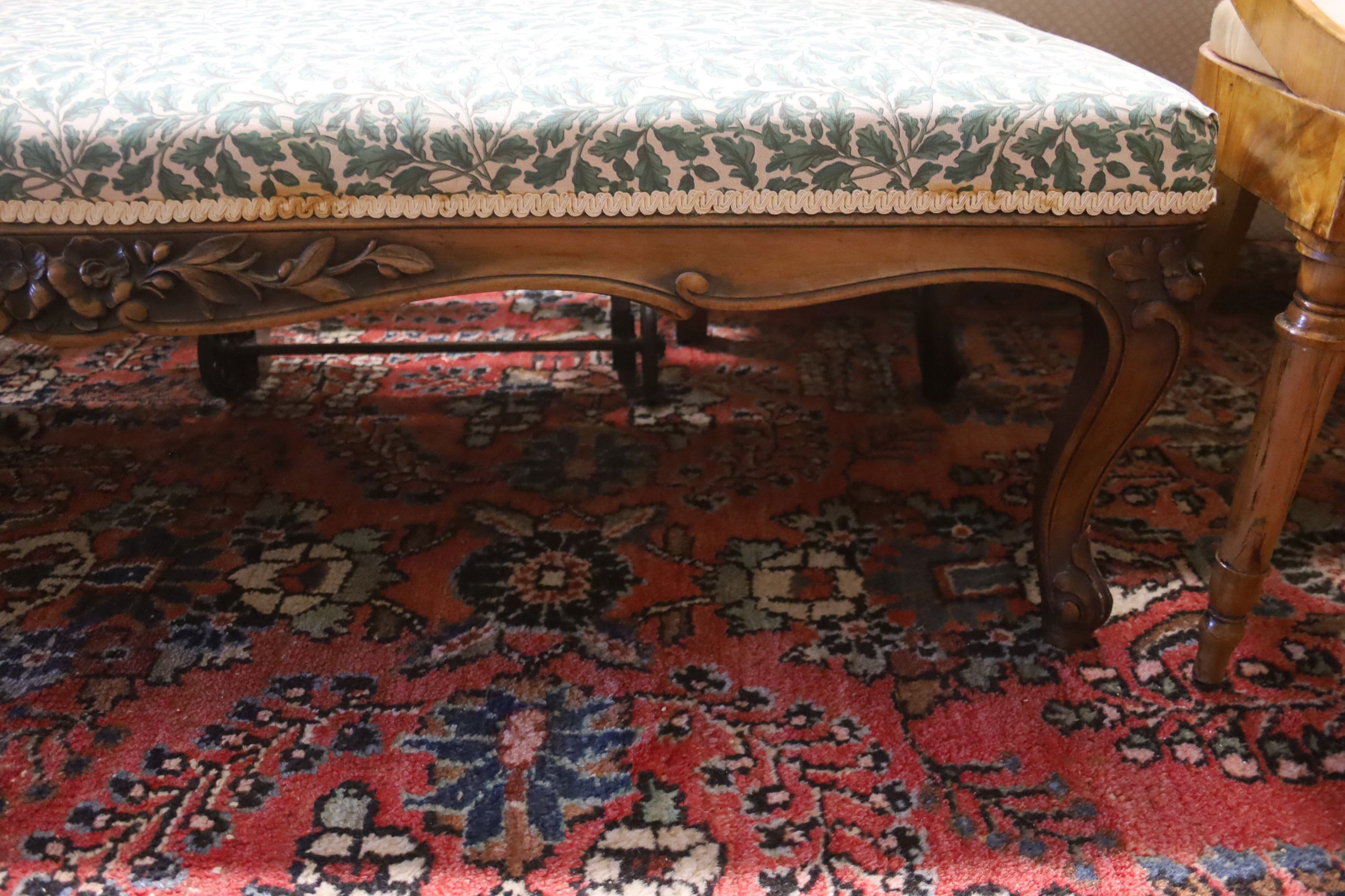 A late 19th century carved walnut upholstered window seat, length 136cm, depth 48cm, height 38cm